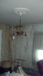 Before living room with pealed wallpaper