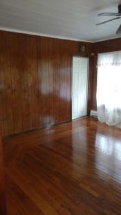 After room with polished wood floors and walls